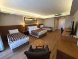 Standard Quadruple room with balcony and with partial sea view